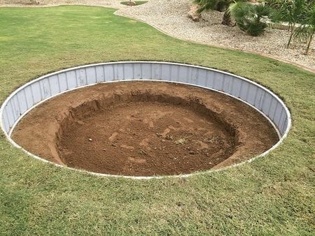 digging a hole to bury a trampoline